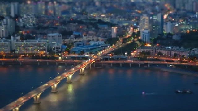 Twilight Cityscape with Illuminated Bridge and River