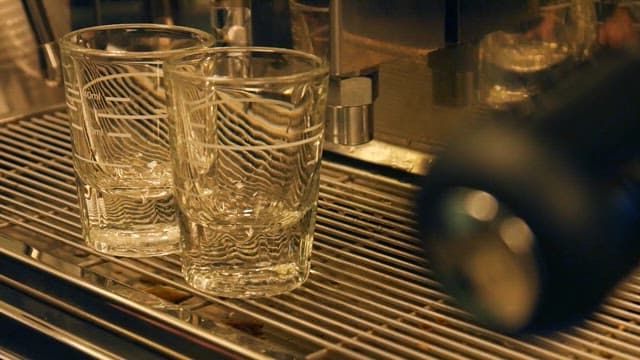 Preparing Espresso in Glass Cups at a Café