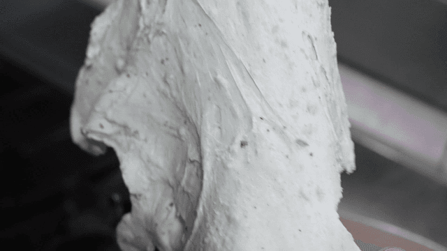 Dough being stretched by hand