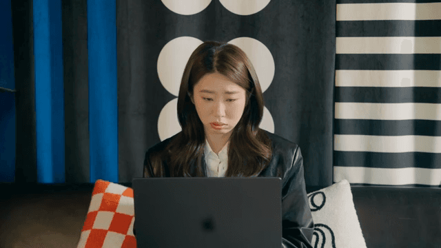 Woman focused on her laptop indoors