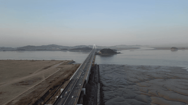 A long bridge over a calm river