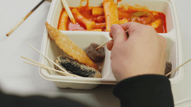 Person eating sundae on a skewer