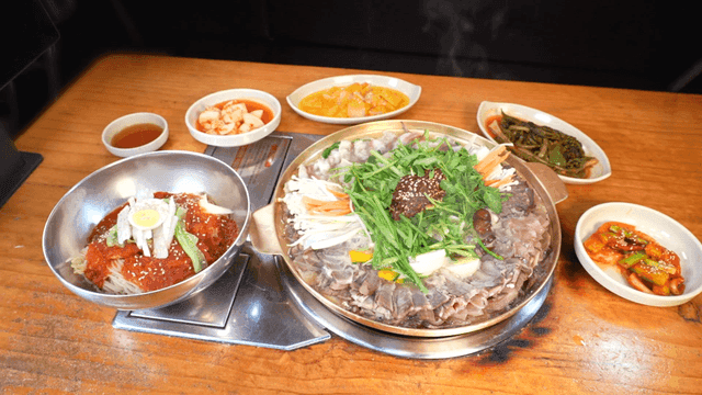 Korean table setting with bibim milmyeon and stew