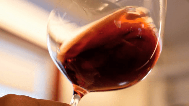 Red wine swirling in a glass