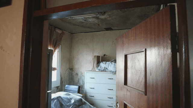 Old room with worn furniture and wallpapers