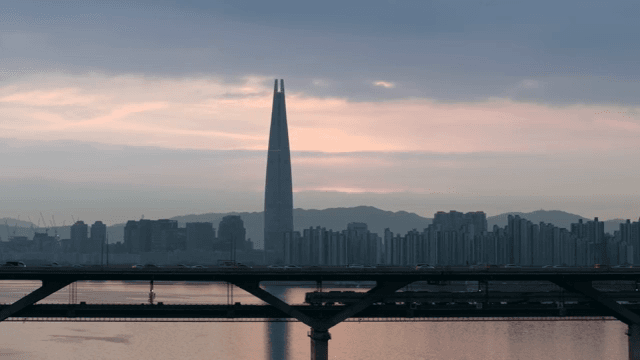 City skyline with a tall tower at dusk