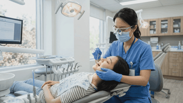 Dentist checking patient's teeth
