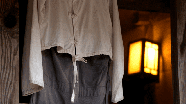 Traditional hanbok hanging on wooden wall
