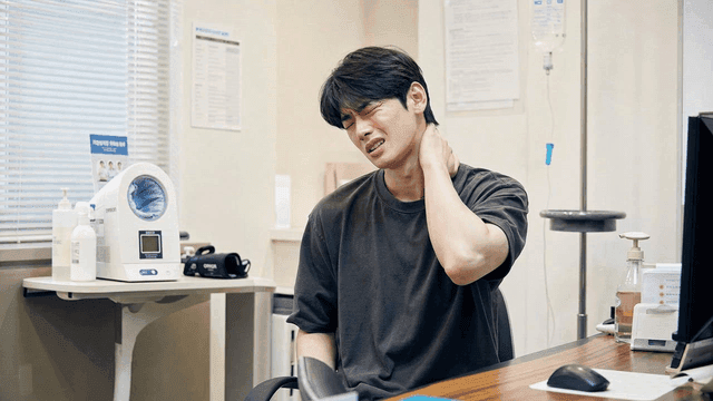 Men suffering from neck pain at clinic
