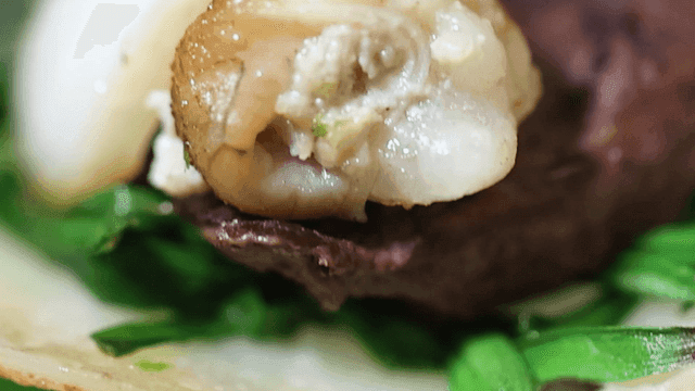 Close-up of Korean dish with beef intestines and vegetables