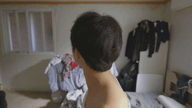 Man catching a bug in a messy room