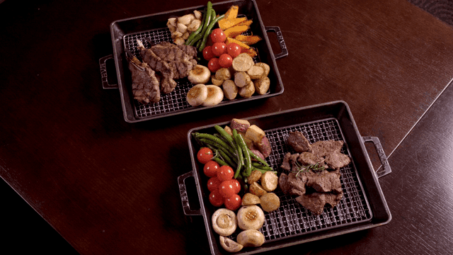 Grilled steak and vegetables on trays