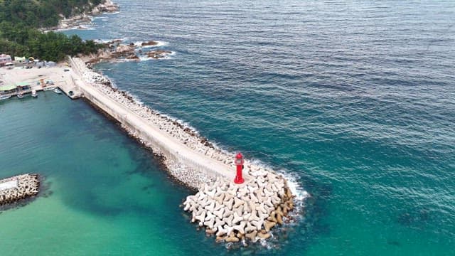 Red lighthouse on a coastal pier