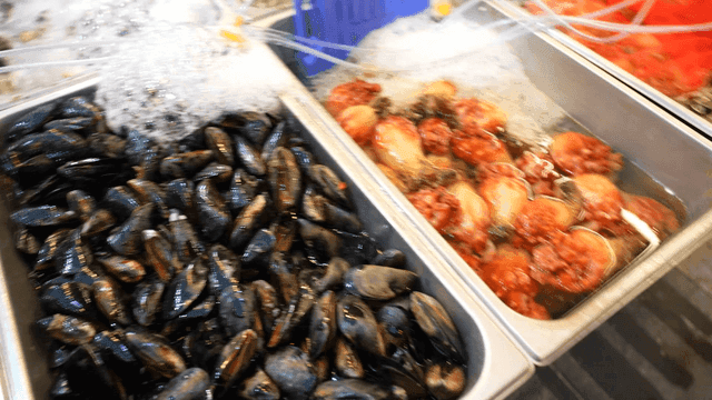 Scallops, mussels, and sea squirts displayed at fish market