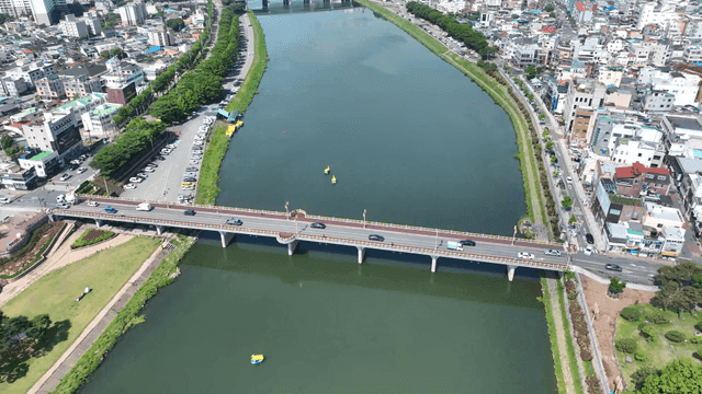 Bridge over a river in a bustling city