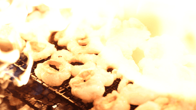 Beef intestines grilling over fire