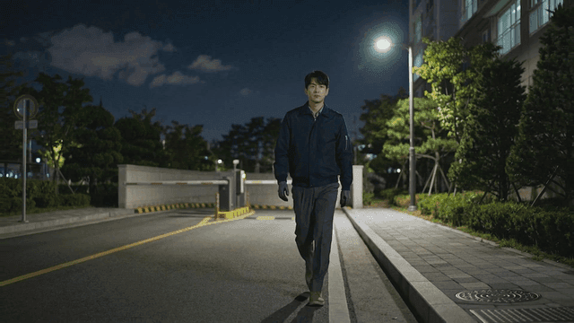 Security guard patrolling quiet streets of apartment complex at night