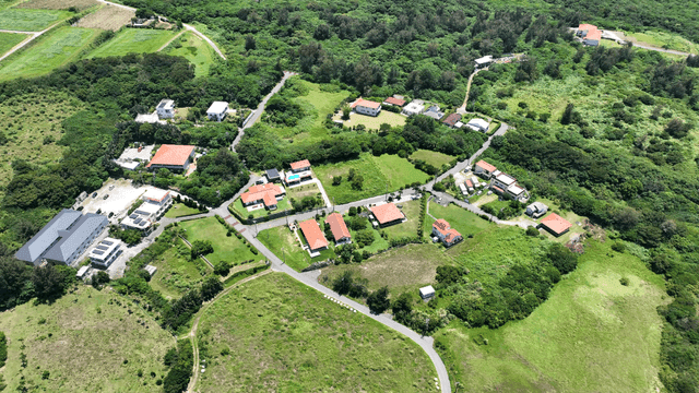 Aerial view of a rural village surrounded by lush greenery