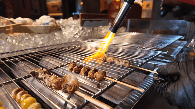 Grilling skewers with a blowtorch