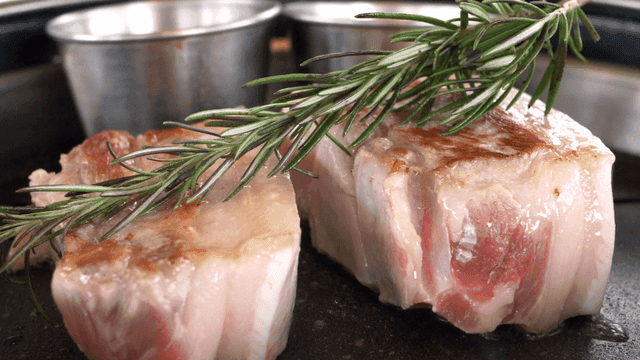 Fresh pork belly with rosemary on grill