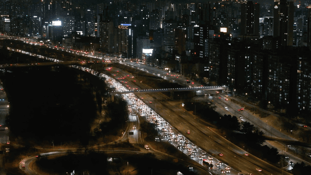 Nighttime city highway with heavy traffic