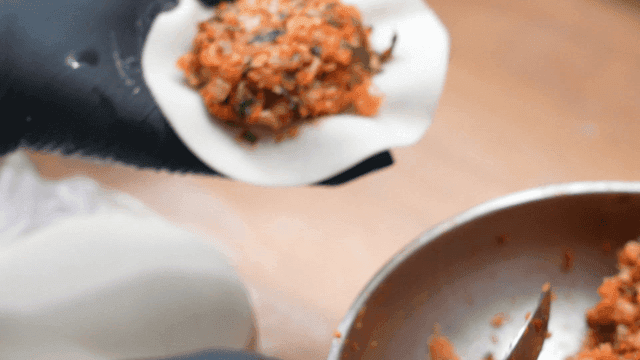 Preparing dumplings with kimchi filling