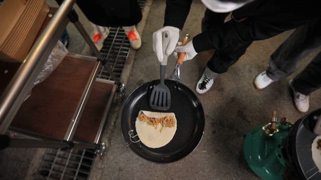 Rolling buckwheat pancakes from a frying pan using a flipper