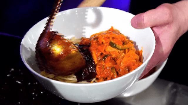 Putting Black Bean Sauce on top of Spicy Seafood Noodle Soup