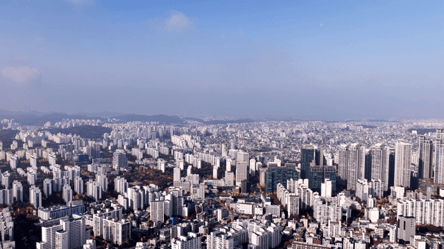 Panoramic view of city spread out under clear sky