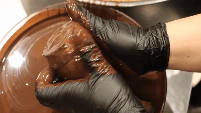 Chocolate-covered bread being prepared