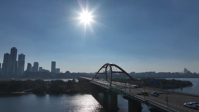 Sunlit Bridge Over Hangang River with Urban Skyline