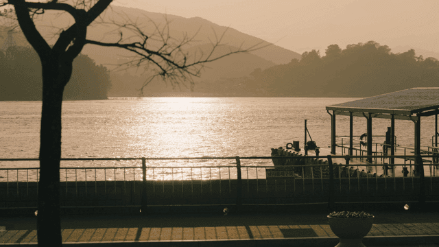 Tranquil riverside scene at sunset