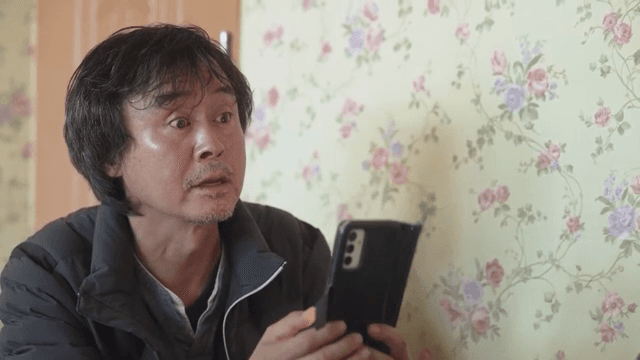 Man talking while putting down his smartphone