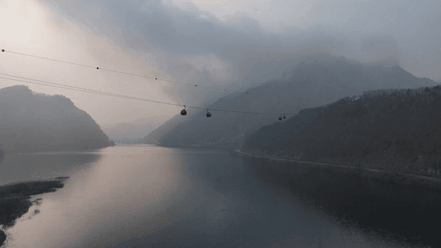 Cable cars over a serene mountain lake