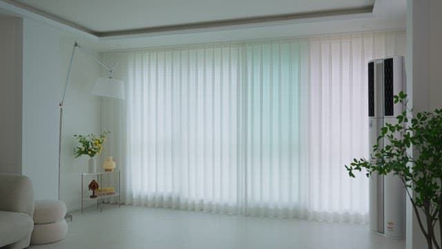 Man opening curtains in modern living room in white interior