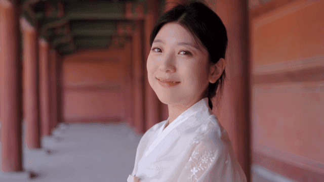 Woman in traditional Korean attire smiling