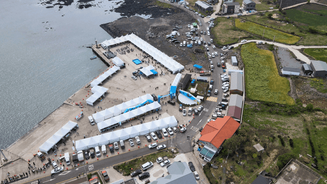 Coastal festival with tents and cars