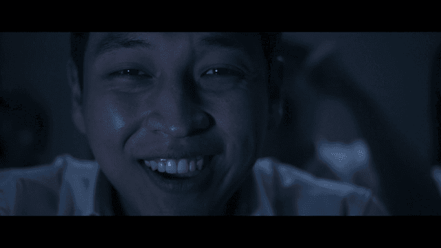 Men rejoicing in dark room