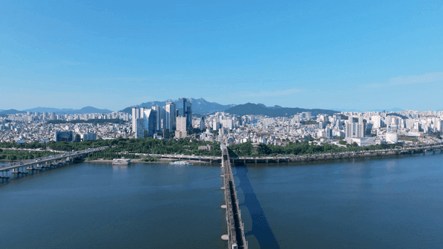 Seoul cityscape with Han River and passing train
