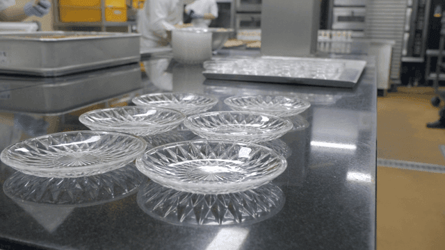 Empty glass plates placed in kitchen where dishes are prepared