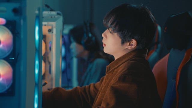 Young adult using a computer in a gaming cafe