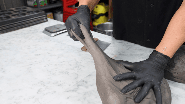 대리석 조리대 위에서 반죽을 소분하는 제빵사