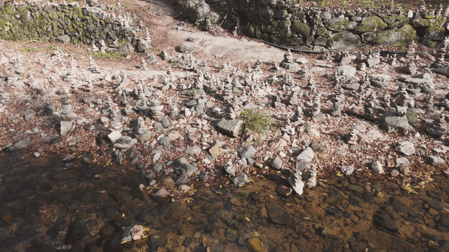 Quiet stream filled with stacked stone towers