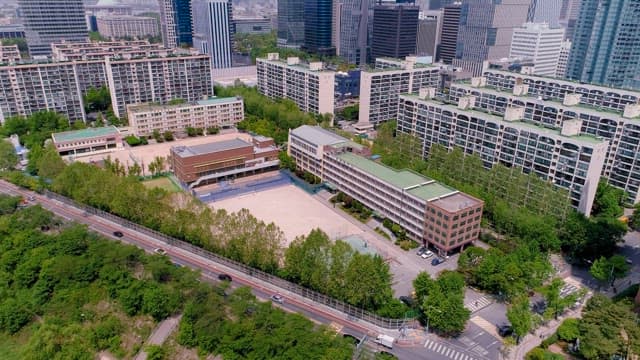 School and Urban Park Surrounded by Buildings