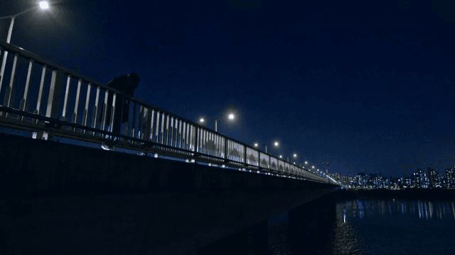 Person climbing on a bridge railing