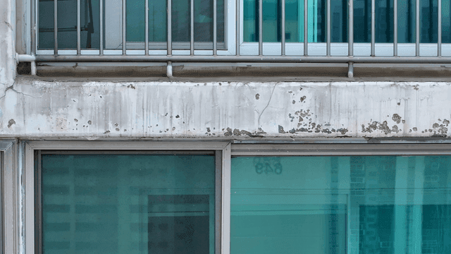 Exterior of a weathered building with windows