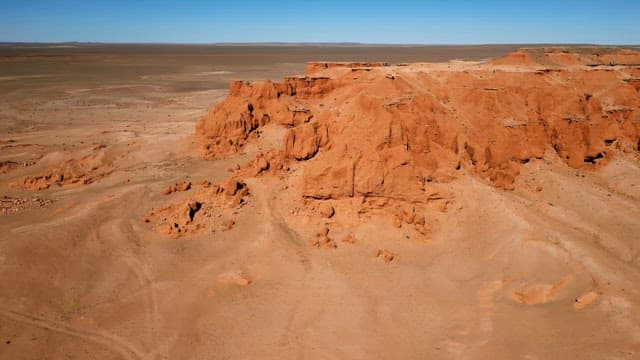 Vast desert landscape with red cliffs