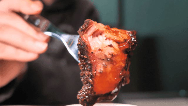Piece of barbecue meat skewered with fork