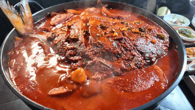 Spicy braised duckfish boiling in pot