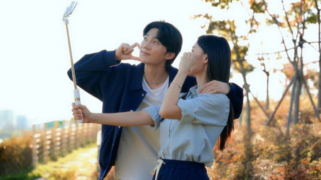 Couple taking selfies in a park